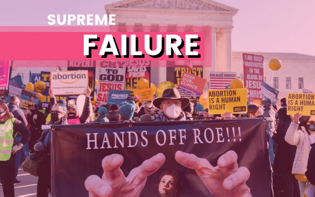 People stand protesting with signs about hands of roe a Supreme Failure. Talked about on We're Gonna Talk About it Podcast